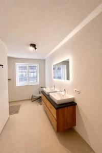 a bathroom with two sinks and a mirror at Staminé in Hochfilzen +18 photos