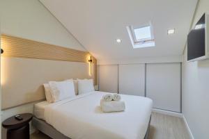 a bedroom with a bed with two towels on it at Setúbal Serenity Villa II, By Home Match in Setúbal