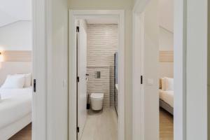 a bathroom with a toilet and a bed in a room at Setúbal Serenity Villa II, By Home Match in Setúbal +15 photos