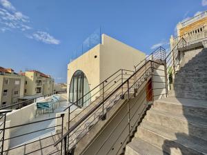 a set of stairs leading up to a building at Butterwave | 1BR Jacuzzi & Terrace in Kfar Aabida in Fad‘ūs