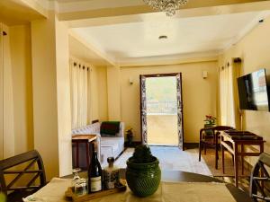 a living room with a couch and a table at Perched on a mountain top, breathtaking city view in Kathmandu