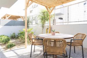 an outdoor patio with a table and chairs at Milva Mare Luxury Apartments in Kos