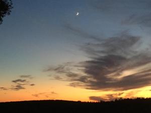 a sunset with the moon in the sky at Herdade do Gamito in Crato