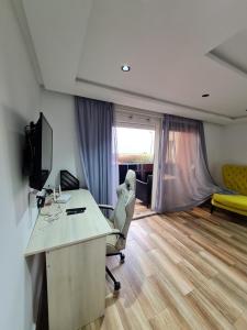 an office with a desk and a chair with a computer at Adnani in Temara