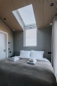 a bedroom with a bed with two towels on it at Green Geysir Cottage in Torfastaðir