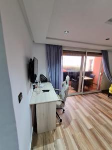 an office with a desk and a chair in a room at Adnani in Temara