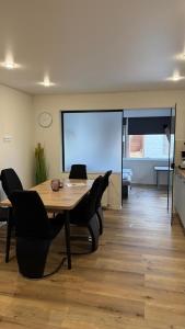 a conference room with a table and chairs and a screen at Fewo An der Weser mit Sauna in Beverungen +2 photos