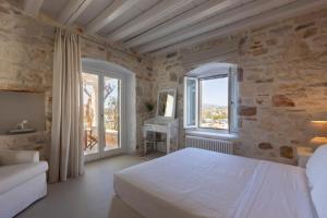 a bedroom with a white bed and a window at Villa Caelia in Santa Maria +30 photos