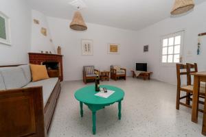 a living room with a couch and a table at Salla Chiotis in Karpathos