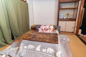 a group of stuffed animals sitting on a chair at FLORAhouse in Oita
