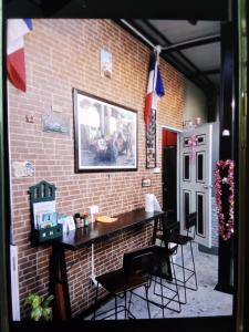 a brick wall with a table and chairs in a room at Turtle Nest in Hua Hin