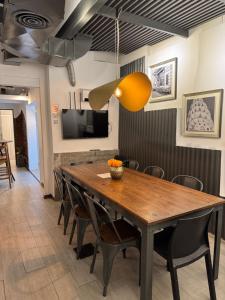 a dining room with a wooden table and chairs at PH Palermo HollyHouse in Buenos Aires