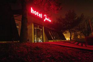 a neon sign in front of a houston clinic at Hotel Junior in Zamość