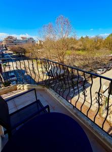 a balcony with benches and a view of a parking lot at B2 Pausilipon Park Corner in Karditsa