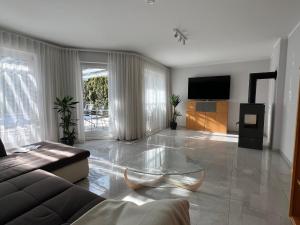 a living room with a couch and a glass table at Haus Lurnfeld in Baldramsdorf