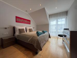 a bedroom with a bed with a red painting on the wall at Haus Lurnfeld in Baldramsdorf +42 photos
