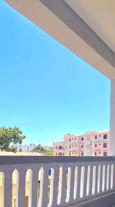 a balcony with a white fence and buildings at The Great Stay Mtwapa in Mtwapa