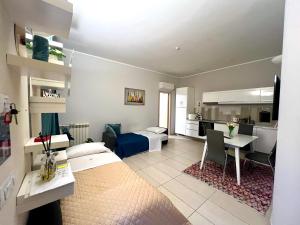 a bedroom with a bed and a desk and a kitchen at ROMA ARCHAEOLOGICAL PARK Apartment in Ostia Antica