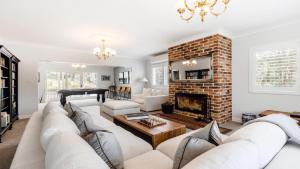 a living room with a couch and a fireplace at Nirvana Estate Macmasters Beach in Macmasters Beach