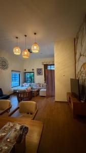 a living room with a couch and a table at Villa Indah sudungdewo in Wonosobo