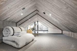 a room with a white couch in a attic at North Suite Eclipse 15A by Hilla Villas in Kittilä