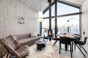 a living room with a couch and a table at North Suite Eclipse 15A by Hilla Villas in Kittilä