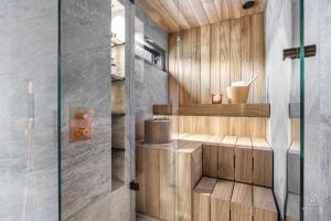 a bathroom with a sauna with a glass door at North Suite Eclipse 15A by Hilla Villas in Kittilä