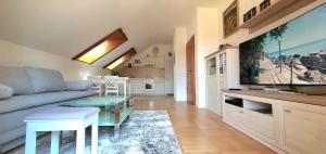 a living room with a couch and a table at Haus an der Mur in Mureck
