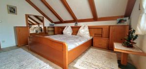 a bedroom with a bed with a wooden frame at Haus an der Mur in Mureck
