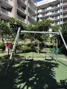 an empty playground in front of a building at Alea Residences 1 Bedroom Condo with Pool View Balcony in Manila
