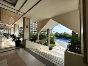 a hallway of a building with a view of a pool at Alea Residences 1 Bedroom Condo with Pool View Balcony in Manila