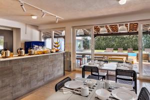 a restaurant with tables and chairs and a kitchen at FreeSurfCamp in Peniche