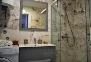 a bathroom with a sink and a shower at Yeshill Deluxe Apartment in Budva +26 photos
