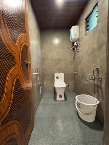 a bathroom with a toilet and a sink at Dandeli River Valley Resort in Dandeli +20 photos