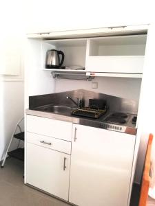 a kitchen with a sink and a stove at Anna in Megali Ammos