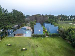 an aerial view of a building in a park at Alaya stays Inara Retreat 1-Cottage with a Mezzanine Loft, Shared Pool, and Garden in Bangalore