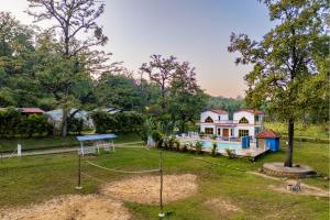 a house with a playground in front of it at Dandeli River Valley Resort in Dandeli
