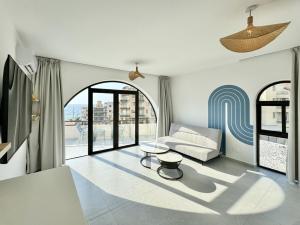 a living room with a couch and a table at Butterwave | 1BR Jacuzzi & Terrace in Kfar Aabida in Fad‘ūs