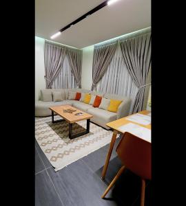 a living room with a couch and a table at Terra Verte Court in Accra