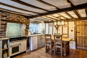 a kitchen with a table and chairs in a room at Finest Retreats - Syncocks Farm Cottage in Petrockstow