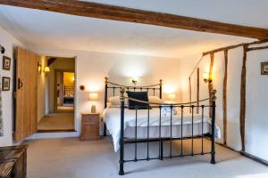 a bedroom with a bed and a hallway at Finest Retreats - Syncocks Farm Cottage in Petrockstow