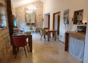 a kitchen and dining room with a table and chairs at La Maison d'Art in Lacour