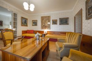 a living room with a table and a couch at Penzion a restaurace U Míšků in Třeboň +20 photos