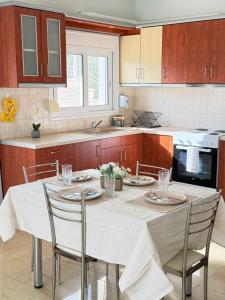 a kitchen with a table with a white table cloth at Apartment Mitrou in Loutra Oraias Elenis