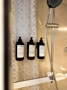 three bottles of soap on a shelf in a bathroom at Daisy's Home Vimmerby in Vimmerby +29 photos