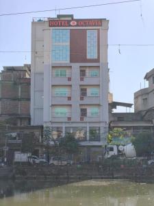 a hotel with a sign on top of a building at Hotel octavia in Imphal