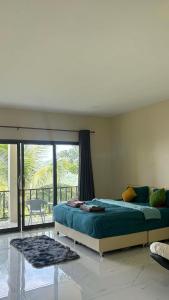 a bedroom with a bed and a large window at Koh tao two view in Ko Tao