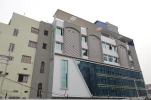 a building with a large window on the side of it at Hotel Pritika Inn in Samastīpur