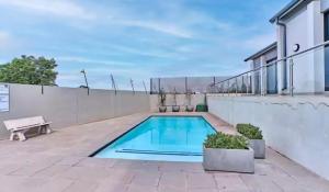 a swimming pool on the roof of a house at Oak and Olive Retreat Midrand in Midrand