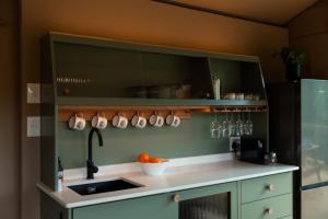 a kitchen with a sink and a counter top at AfriCamps at Gowan Valley in Balgowan +46 photos